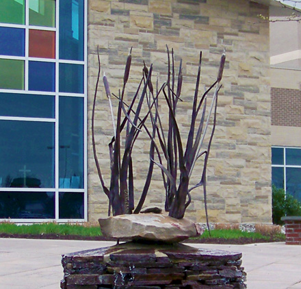 Artist blacksmith fountain with forged cattails